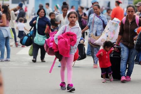 Venezuelans enter the Binational Border Service Center of Peru after a new migration law was imposed for all Venezuelan migrants to have valid visas and passports, in Tumbes