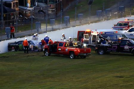 NASCAR Xfinity Series driver Kyle Busch (54) is attended to by medical staff after a wreck during the Alert Florida 300 at Daytona International Speedway. Andrew Weber-USA TODAY Sports