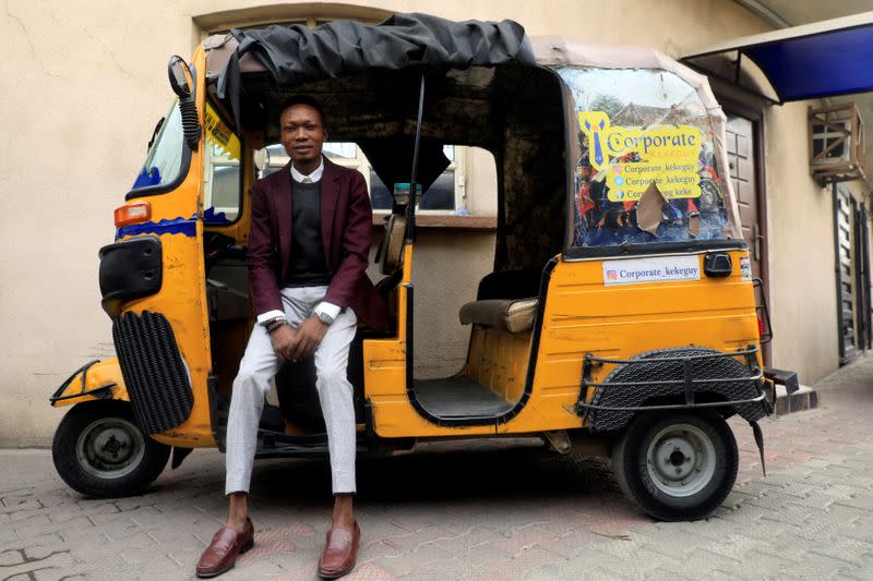 Samuel Ogundare, CEO of Corporate Keke Guy, poses for a photo in his tricyle popularly known as 'keke' in Lagos