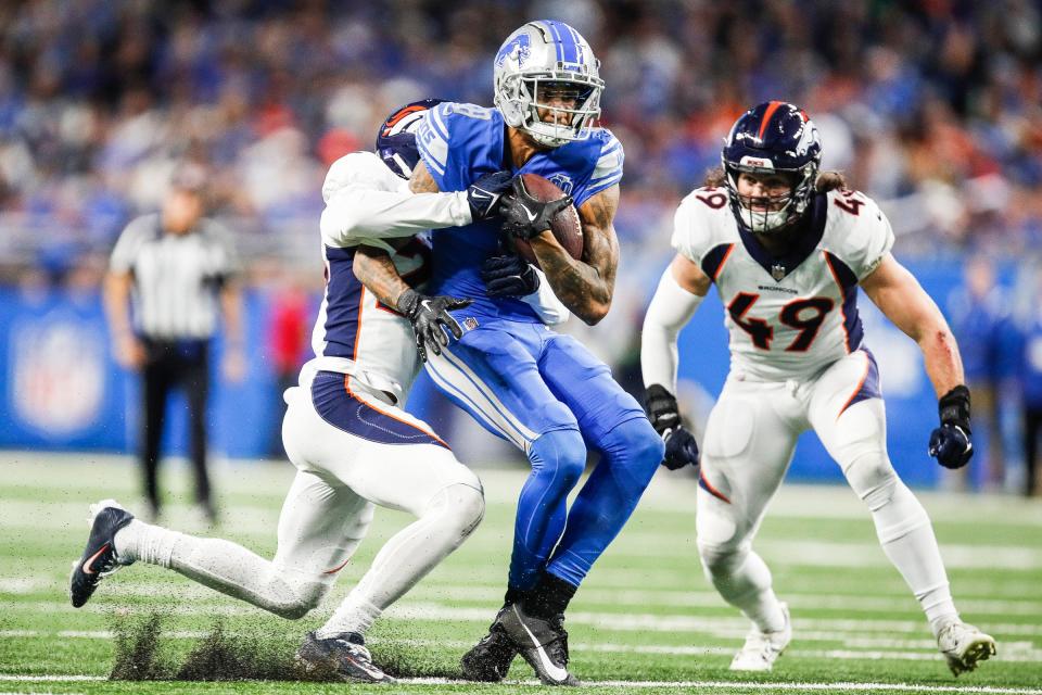 Detroit Lions wide receiver Josh Reynolds makes a catch against Denver Broncos cornerback Fabian Moreau and linebacker Alex Singleton during the first half at Ford Field in Detroit on Saturday, Dec. 16, 2023.