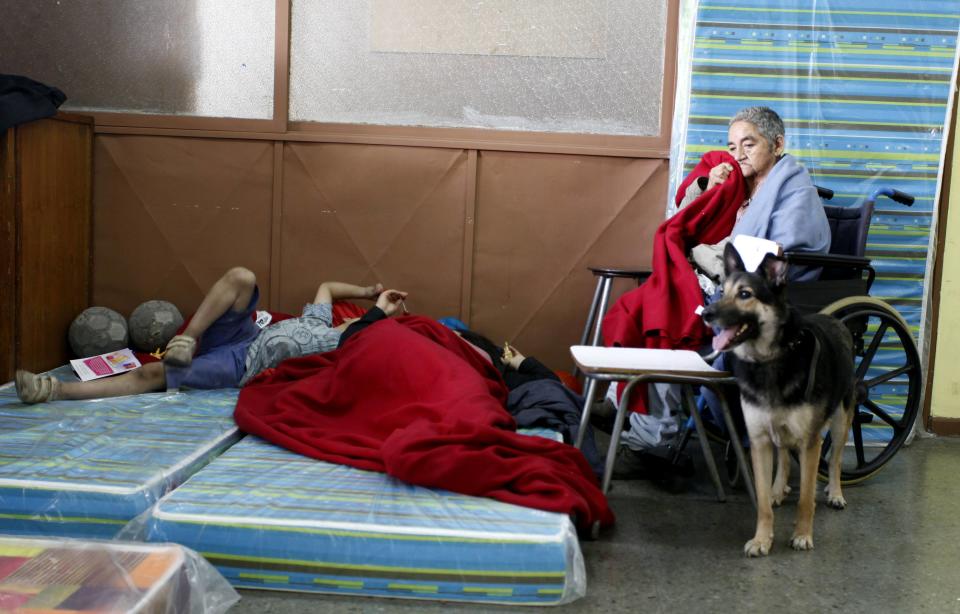 Residents gather in a shelter after a forest fire burned several neighbourhoods in the hills of Valparaiso city