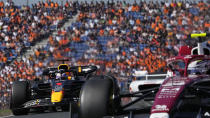 Red Bull driver Max Verstappen of the Netherlands overtakes Alfa Romeo driver Zhou Guanyu of China, right, during the third practice session ahead of Sunday's Formula One Dutch Grand Prix auto race, at the Zandvoort racetrack, in Zandvoort, Netherlands, Saturday, Sept. 3, 2022. (AP Photo/Peter Dejong)