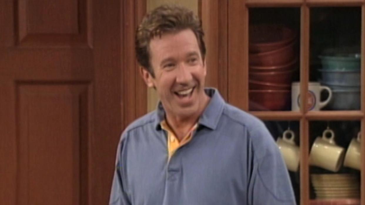  Tim Taylor smiling inside house in Home Improvement. 