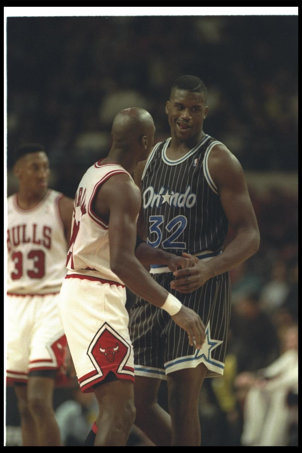 Shaquille O'Neal confers with guard Michael Jordan of the Chicago Bulls during a game at the United Center in Chicago, Illinois. (Jonathan Daniel /Allsport)