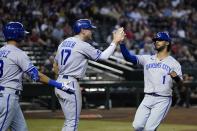 Kansas City Royals' MJ Melendez (1) celebrates with Hunter Dozier (17) and Nicky Lopez, left, after Melendez scored against the Arizona Diamondbacks during the sixth inning of a baseball game Tuesday, May 24, 2022, in Phoenix. (AP Photo/Ross D. Franklin)