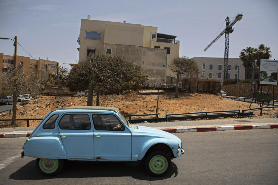 A crane is used in new construction, in the Jaffa neighborhood of Tel Aviv, Israel, Wednesday, April 21, 2021. Historic Jaffa's rapid gentrification in recent years is coming at the expense of its mostly Arab lower class. With housing prices out of reach, discontent over the city’s rapid transformation into a bastion for Israel’s ultra-wealthy is reaching a boiling point. (AP Photo/Sebastian Scheiner)