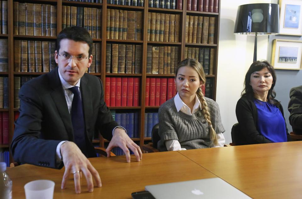 Peter Sahlas, left, the US lawyer representing Mukhtar Ablyazov speaks as his wife Alma Shalabayeva, right, and daughter Madina Ablyazova, centre listen, during a press conference, in Paris, Tuesday Jan. 7, 2014. An opposition leader from a country that has been ruled by the same man since 1989, a former banker accused of siphoning off billions, Mukhtar Ablyazov has been jailed since police special forces seized him July 31 in the south of France. (AP Photo/Remy de la Mauviniere)