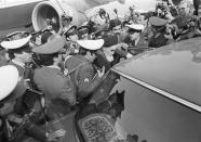 FILE - In this Feb. 1, 1979 file photo, exiled Ayatollah Ruhollah Khomeini has a heavy escort as he enters car to leave the airport in Tehran, Iran. Friday, Feb. 1, 2019 marks the 40th anniversary of Ayatollah Ruhollah Khomeini return to Tehran, a moment that changed the country’s history for decades to come. The revolution would spark the U.S. Embassy takeover and hostage crisis, stoking the animosity that exists between Tehran and Washington to this day. (AP Photo/FY, File)