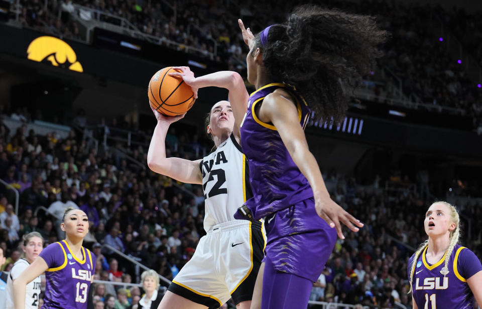 Caitlin Clark #22 of the Iowa Hawkeyes shoots the ball while defended by Angel Reese #10 of the LSU Tigers during the finals of the NCAA Women's Basketball Tournament in April. / Credit: / Getty Images