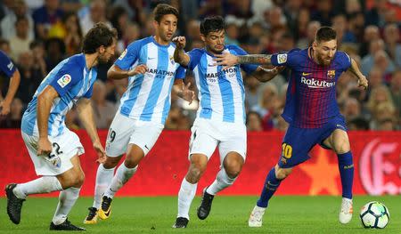 Soccer Football - La Liga Santander - FC Barcelona vs Malaga CF - Camp Nou, Barcelona, Spain - October 21, 2017 Barcelona’s Lionel Messi in action with Malaga's Gonzalo Castro REUTERS/Albert Gea