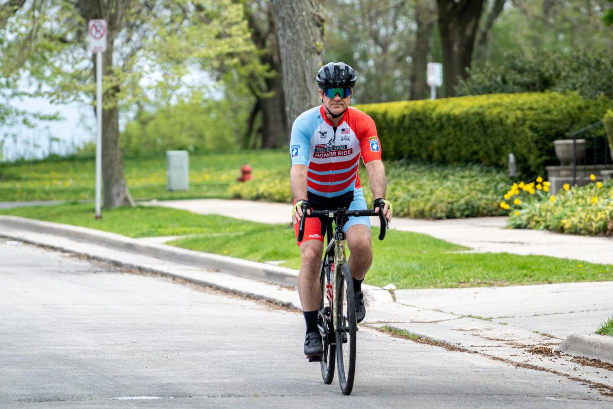 Retired U.S. Army Col. Chris Kolenda trains for a 1,700-mile cycling tour on Tuesday in Milwaukee. The cycling tour will consist of visiting the gravesites of six members of his military unit who were killed in action in Afghanistan. He is also raising funds for the Saber Six Foundation, which helps the unit's veterans.