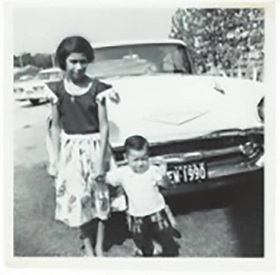 Eight-year-old Leticia Perez holds the hand of 1 ½-year-old Emerico Perez Jr. on the 3300 block of West Rosedale in the TP barrio in 1962.