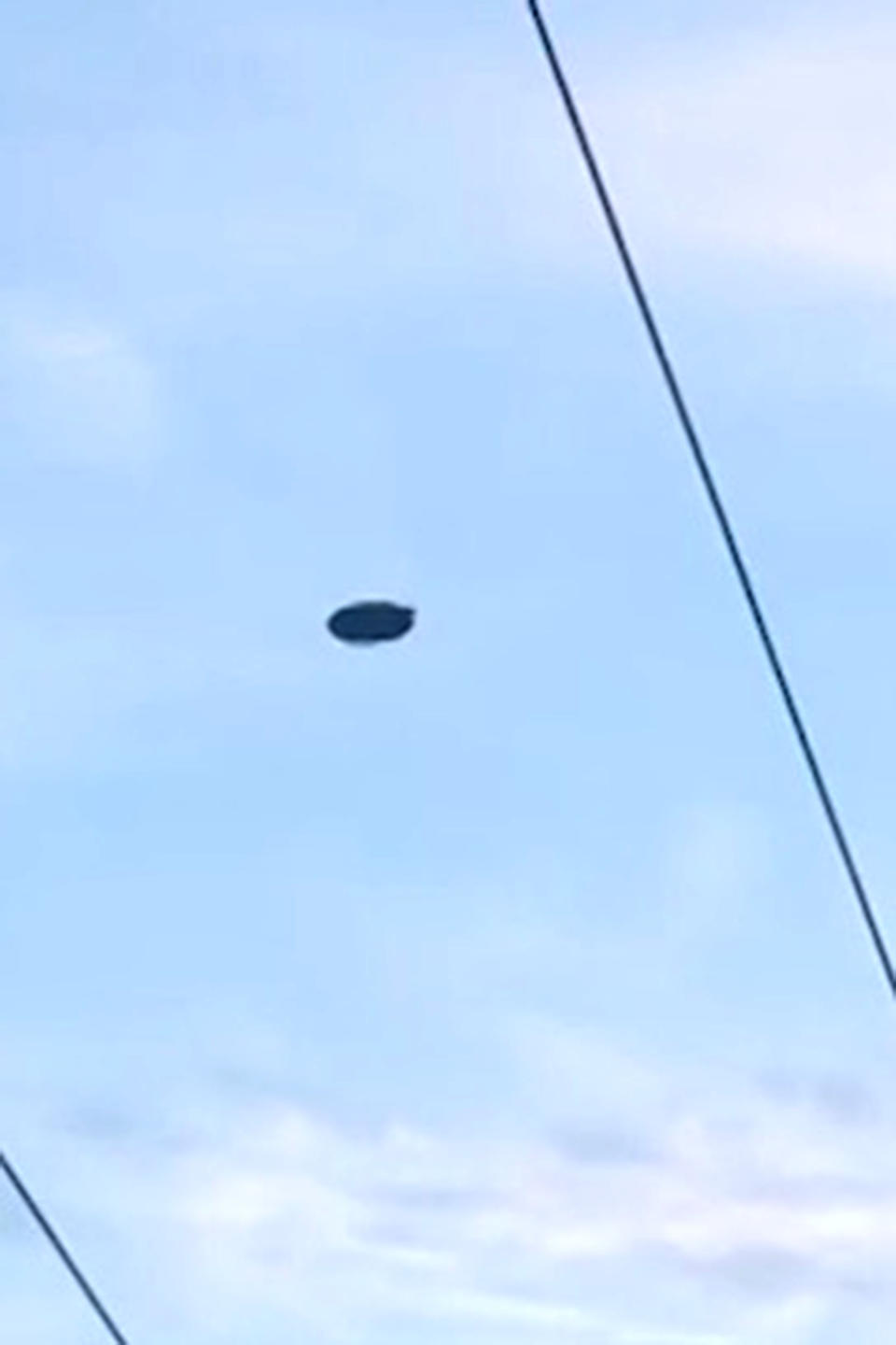 Junelyn Bitalac was returning from dropping her mum off at work in Hastings, a suburb of Melbourne, on the morning of May 28 when she noticed the black object hovering in the sky. Photo: Caters