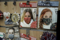 A Christmas themed face mask to try to curb the spread of coronavirus is displayed in the front window of a store selling items aimed at tourists in central London, Wednesday, Oct. 21, 2020. The South Yorkshire region of northern England is being placed under the country's tightest restrictions to curb the coronavirus — joining a densely populated swathe of the country where the measures have been imposed despite protests from local politicians. (AP Photo/Matt Dunham)