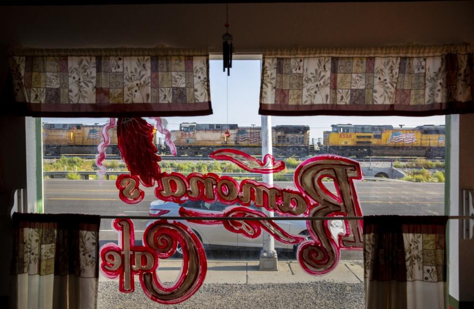 A freight train heading west toward Tucson rolls past Ramona's Cafe.