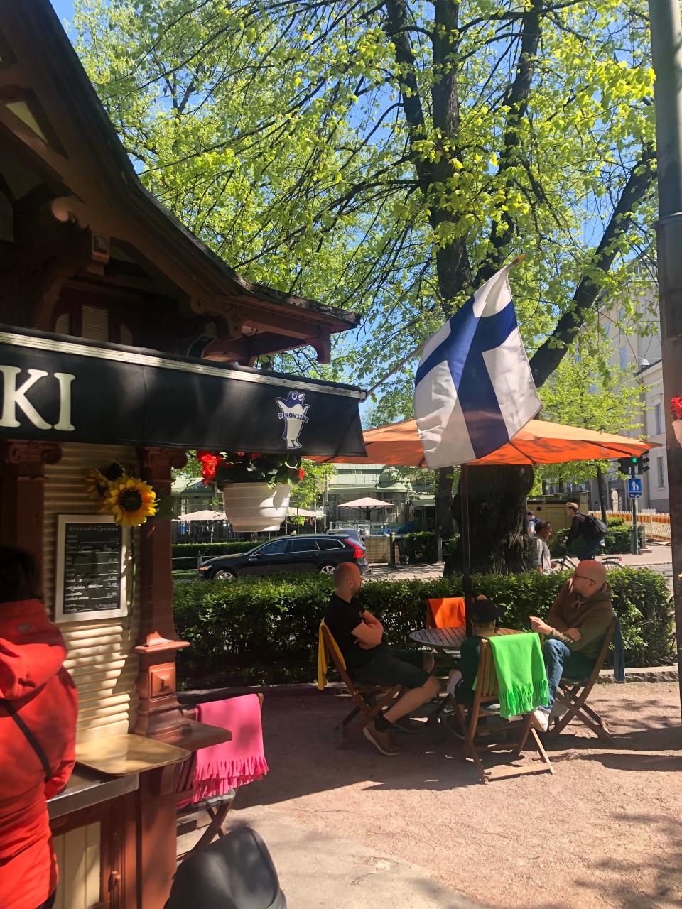 People sit outside a cafe in Helsinki