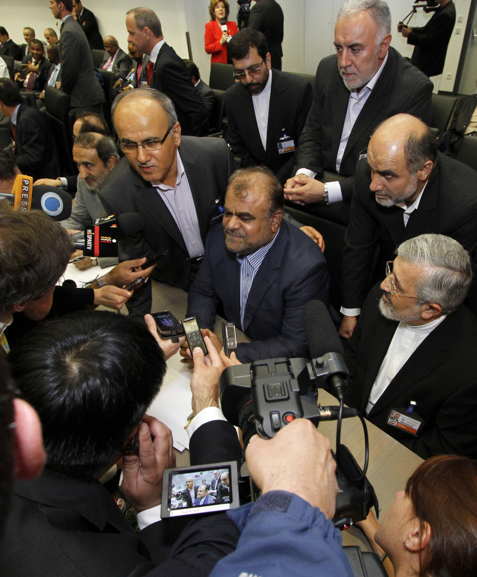 Iran's Minister of Petroleum Rostam Ghasemi, center, is surrounded by delegates and media prior to the start of the meeting of the Organization of the Petroleum Exporting Countries, OPEC, at their headquarters in Vienna, Austria, on Thursday, June 14, 2012. The meeting of the 12 oil ministers of the OPEC focuses on price and production targets. (AP Photo/Ronald Zak)