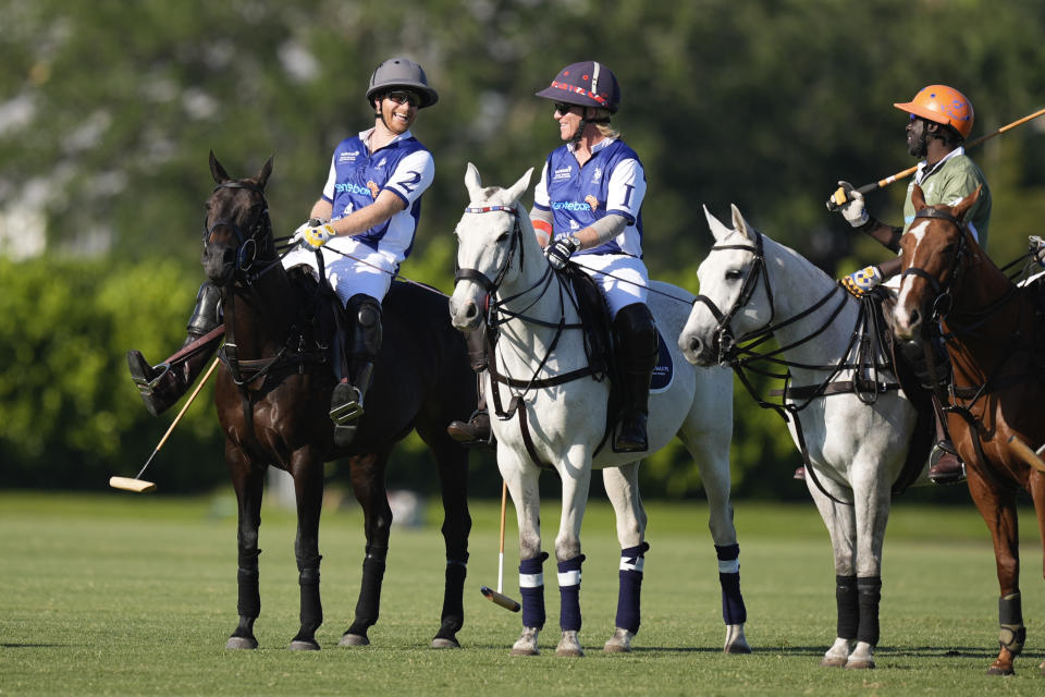 Britain's Prince Harry, left, talks with other players at the start of the 2024 Royal Salute Polo Challenge to Benefit Sentebale, Friday, April 12, 2024, in Wellington, Fla. Prince Harry, co-founding patron of the Sentebale charity, will play on the Royal Salute Sentebale Team. (AP Photo/Rebecca Blackwell)