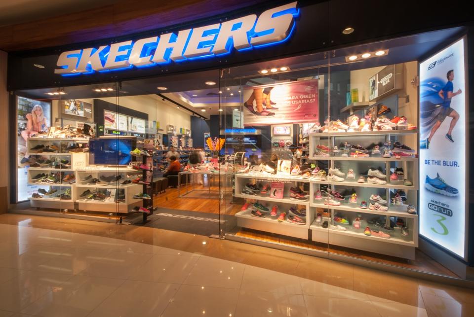 Skechers retail store as seen from outside, with lots of shoe displays.