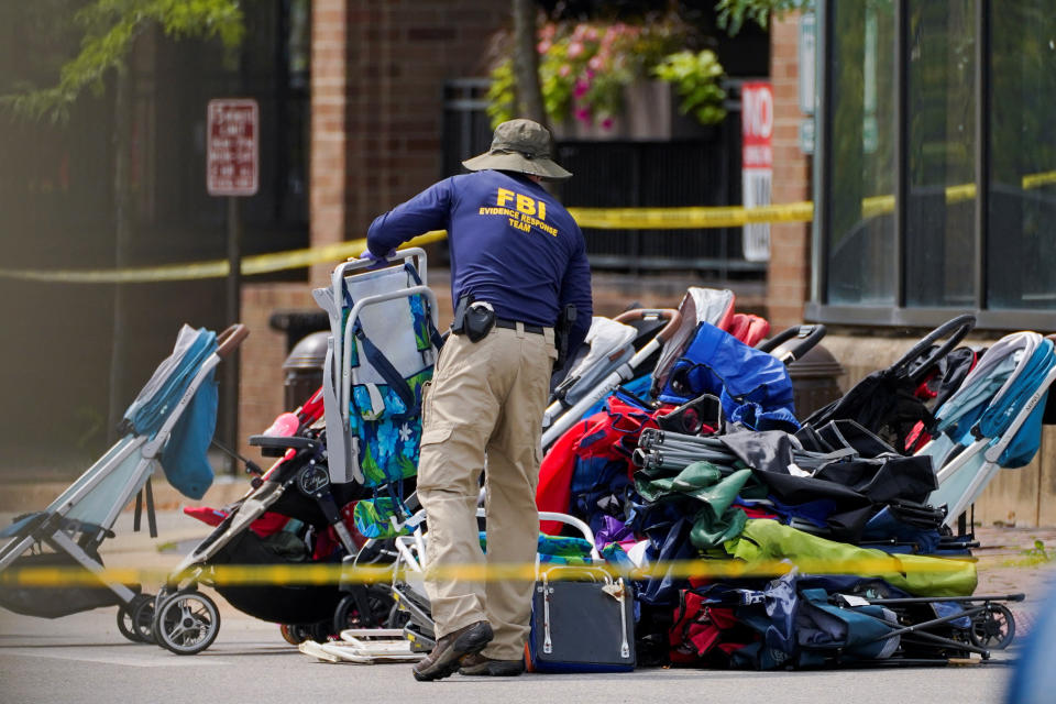 An FBI agent attends to an array of more than a dozen abandoned strollers.