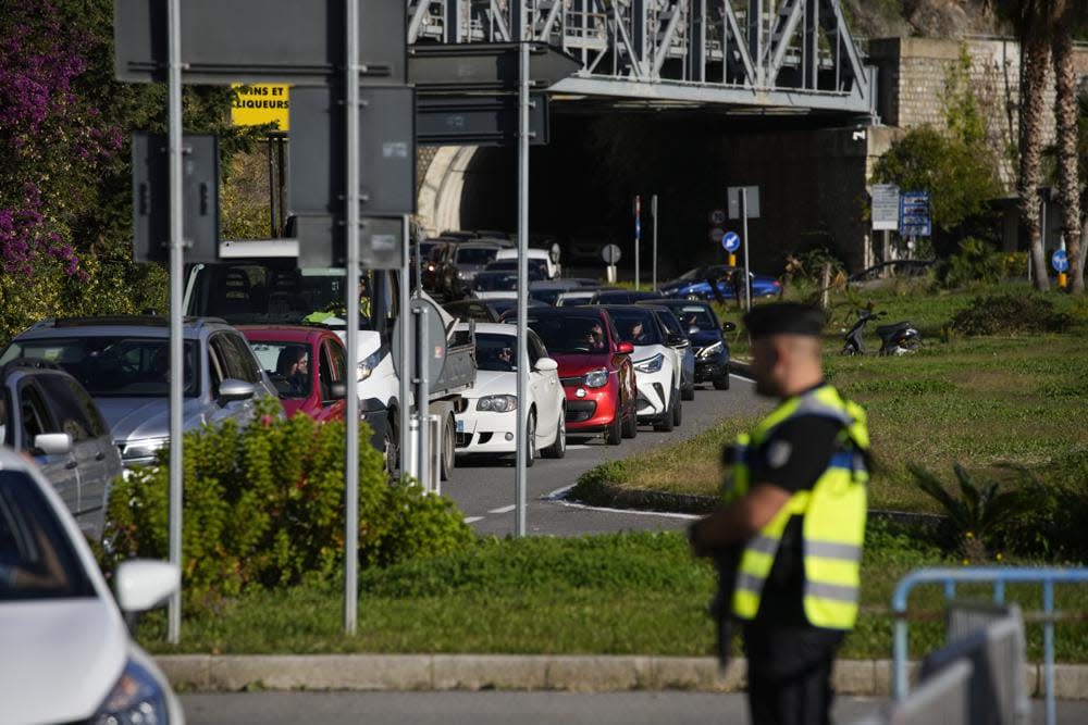 Cars line up for police checks before entering France from Italy at a border crossing in Menton, southern France, Sunday, Nov. 13, 2022. Lines formed Sunday at one of Italy’s northern border crossings with France following Paris’ decision to reinforce border controls over a diplomatic row with Italy about migration policy and humanitarian rescue ships that shows no end in sight. (AP Photo/Daniel Cole)