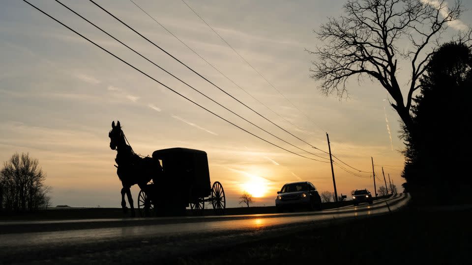 An Amish buggy shares the road with automobiles in Strasburg, Pennsylvania. - Charly Triballeau/AFP/Getty Images