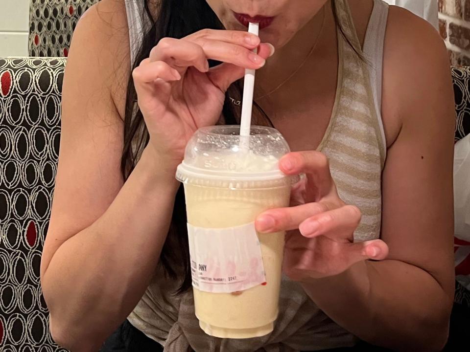 tiffany drinking a peach milkshake from chick fil a in toronto