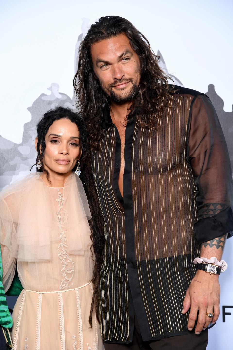 Lilakoi Moon (Lisa Bonet) and Jason Momoa at Fendi Couture Fall/Winter 2020 on July 04, 2019 in Rome, Italy.  Momoa wears a scrunchie.