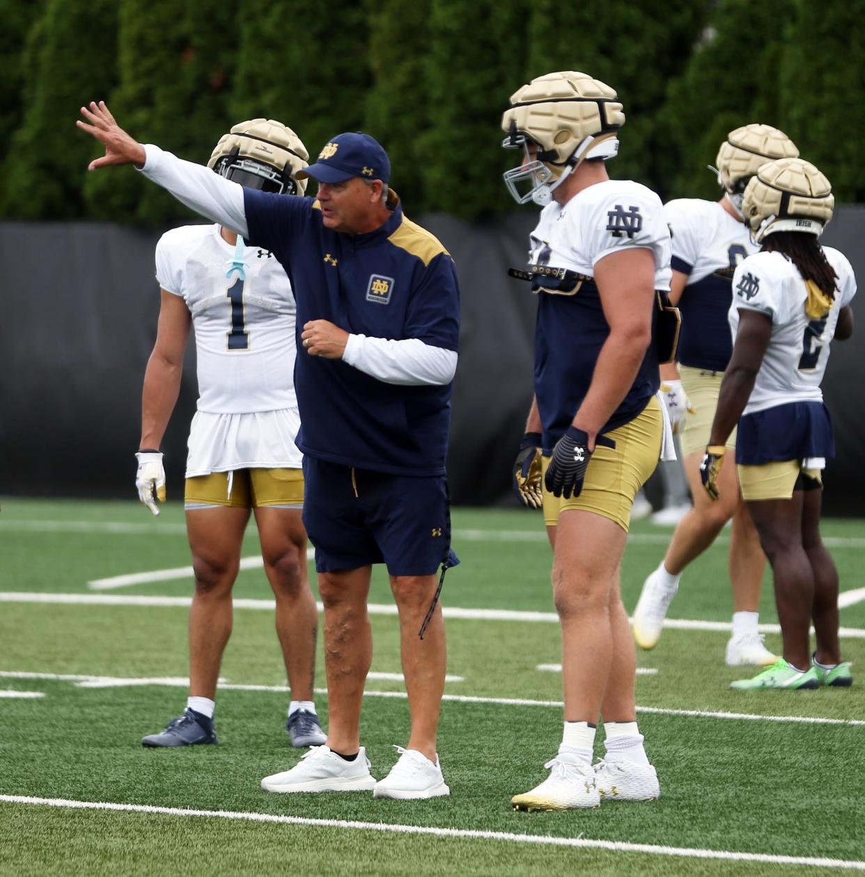 Notre Dame offensive coordinator Mike Denbrock gives instructions to senior tight end Kevin Bauman during a practice Friday, August 2, 2024, at the Irish Athletics Center in South Bend.