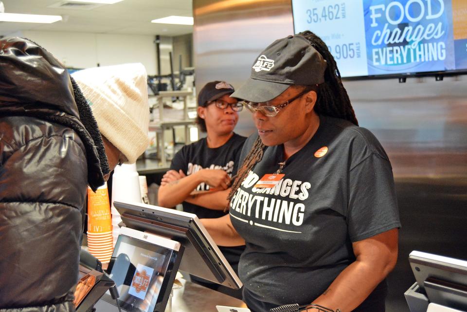 Tacos 4 Life employee Yoshi Rucker takes an order last December during the fast casual chain restaurant's opening day on Green Meadows Road in Columbia.