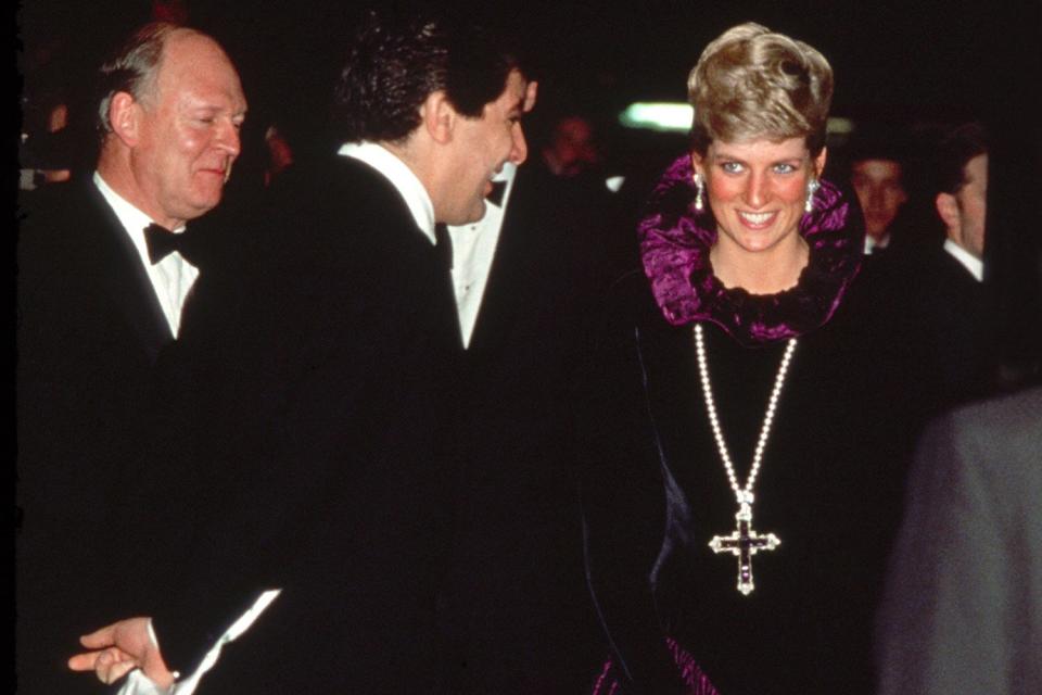 Diana, Princess Of Wales, Arriving At A Charity Gala Evening On Behalf Of Birthright At Garrard. The Princess Is Wearing A Purple Evening Dress With A Gold And Amethyst Crucifix Suspended On A Pearl Rope.