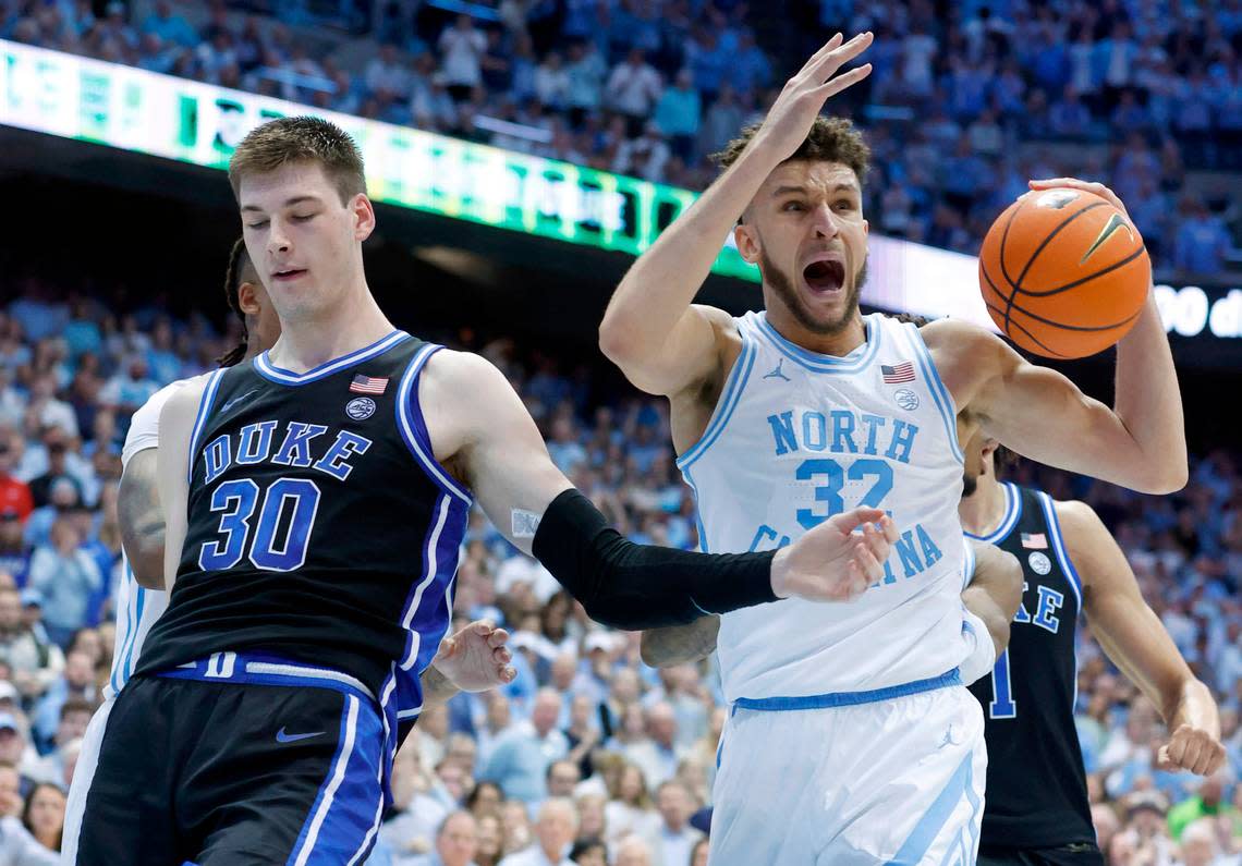 North Carolina’s Pete Nance (32) can’t believe he was called for the foul on Duke’s Kyle Filipowski (30) during the second half of Duke’s 62-57 victory over UNC at the Smith Center in Chapel Hill, N.C., Saturday, March 4, 2023.