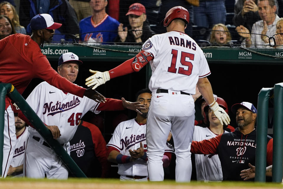 Washington Nationals' Riley Adams celebrates his solo home run with his teammates during the fifth inning of a baseball game against the New York Mets at Nationals Park, Tuesday, May 10, 2022, in Washington. (AP Photo/Alex Brandon)