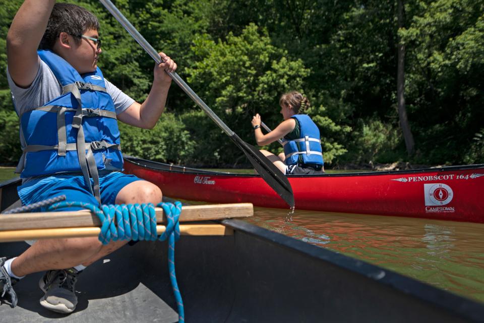 Daniel McShane guides his canoe past Camptown staffer Josie Heidlage on Delaware Lake, Thursday, June 30, 2022 at Fort Harrison State Park. Share LT students from Belzer Middle School and Fall Creek Valley Middle School canoed, fished, hiked and did a creek study with Camptown.