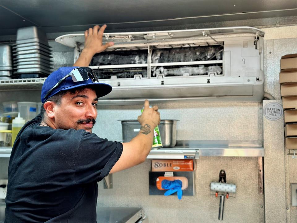 Side Eye Pie owner Tony Curet has learned how to service his trailer's air conditioner in an effort to battle the searing temperatures.