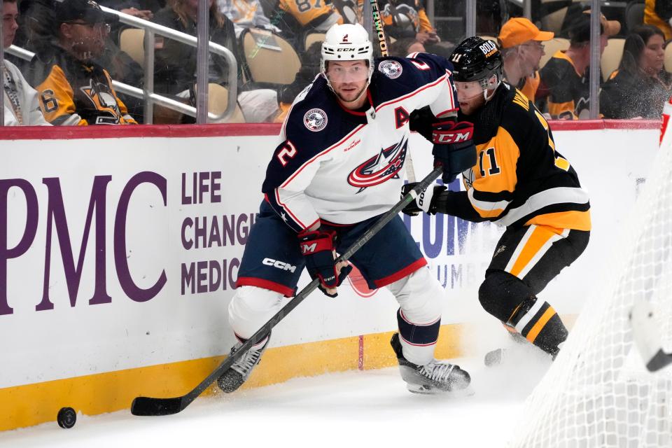 Columbus Blue Jackets' Andrew Peeks (2) controls the puck behind the net against Pittsburgh Penguins' Alex Nylander (11) during the second period of a preseason NHL hockey game in Pittsburgh, Sunday, Sept. 24, 2023. (AP Photo/Gene J. Puskar)
