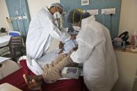 Dr. Kedar Toraskar checks a COVID-19 patient at the Mumbai Central Wockhardt Hospital in Mumbai, India, June 4, 2021. The recent coronavirus surge in India affected young people on a scale his team of critical care doctors hadn’t previously seen. (AP Photo/Rajanish Kakade)