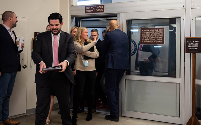 en. Cory Booker (D-N.J.) holds the malfunctioning door in the Senate Subway