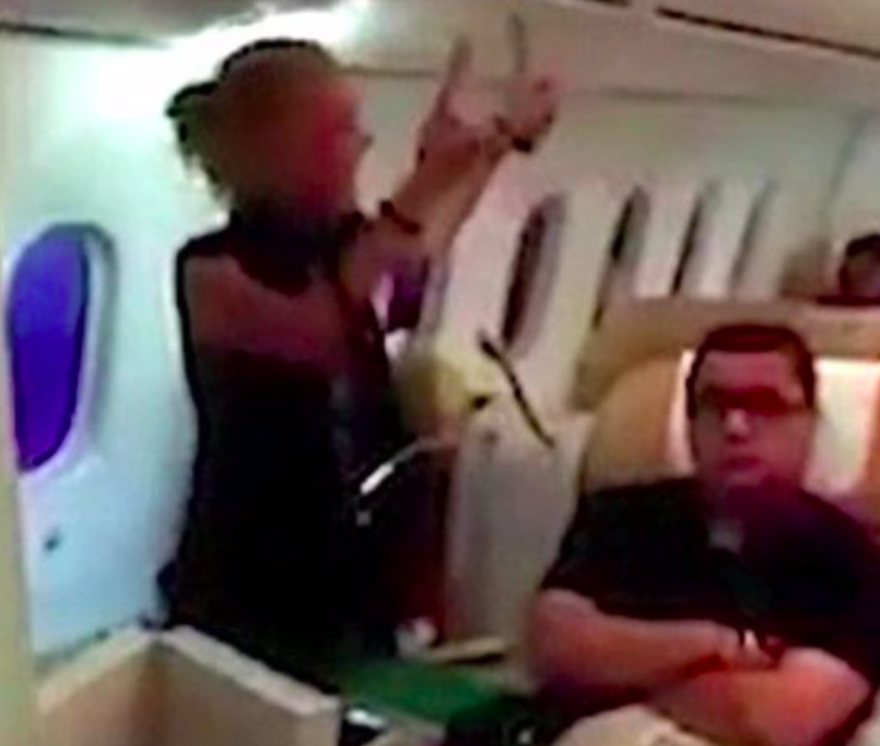 Burns was filmed swearing and spitting on an Air India flight (Grab) 