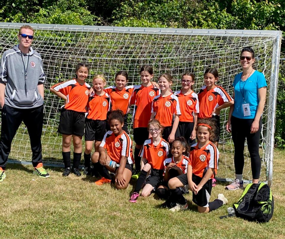 A Chair City  Grade 3/4 girls soccer team, thanks to a nomination from an anonymous parent, recently celebrated its season with a pizza party courtesy of Papa Gino’s and its “Pizza My Heart” program. The initiative seeks to recognize individuals, teams or organizations within a community who are deserving of a “pizza pick me up.” Head coach Mike Reppucci said his team made huge improvements as soccer players thanks to their inspirational work ethic and willingness to learn in practice. Back row (from left to right): Coach Reppucci, Romina, Giuliana, Emma, Brooke, Liana, Alivia, Marjorie, and Coach Andrea Carr. Front Row: Mya, Lily, Jasmine, Sophia.