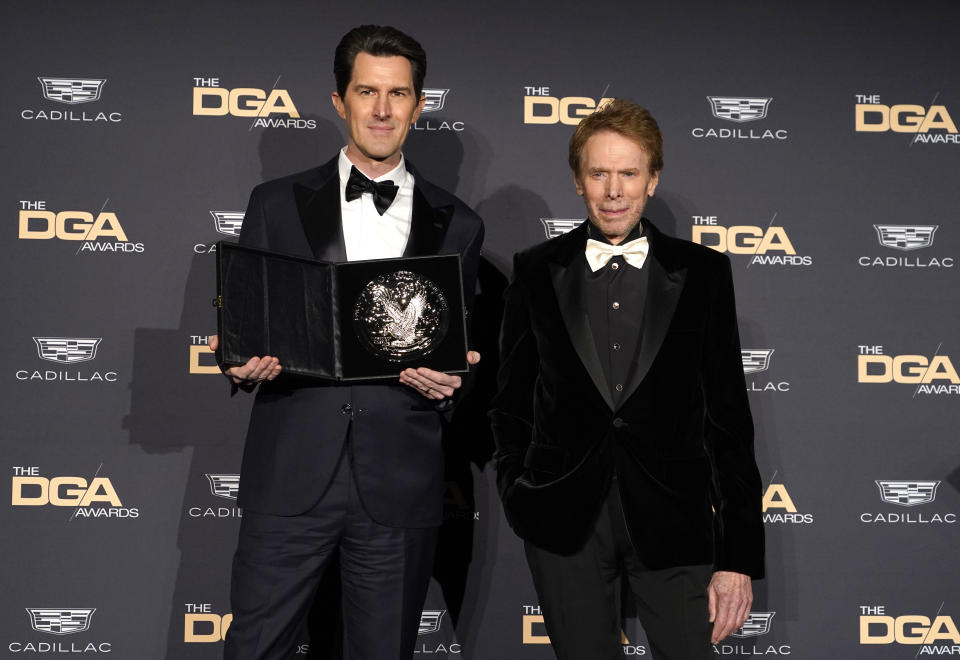 Joseph Kosinski, nominee for outstanding directorial achievement in theatrical feature film for "Top Gun: Maverick," left, and presenter Jerry Bruckheimer pose in the press room at the 75th annual Directors Guild of America Awards on Saturday, Feb. 18, 2023, at the Beverly Hilton hotel in Beverly Hills, Calif. (AP Photo/Chris Pizzello)