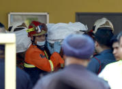 <p>The body of a victim is carried out by rescue personnel from an Islamic religious school after a fire on the outskirts of Kuala Lumpur Thursday, Sept. 14, 2017. (Photo: Daniel Chan/AP) </p>