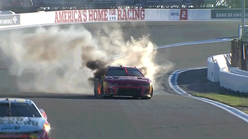Ricky Stenhouse Jr. climbing out of his burning car during the Bank of America Roval 400