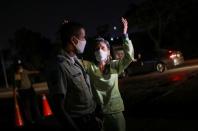 Doctor Julia Borges argues with a police officer at a checkpoint near a gas station, during a nationwide quarantine due to the coronavirus disease (COVID-19) outbreak, in Caracas