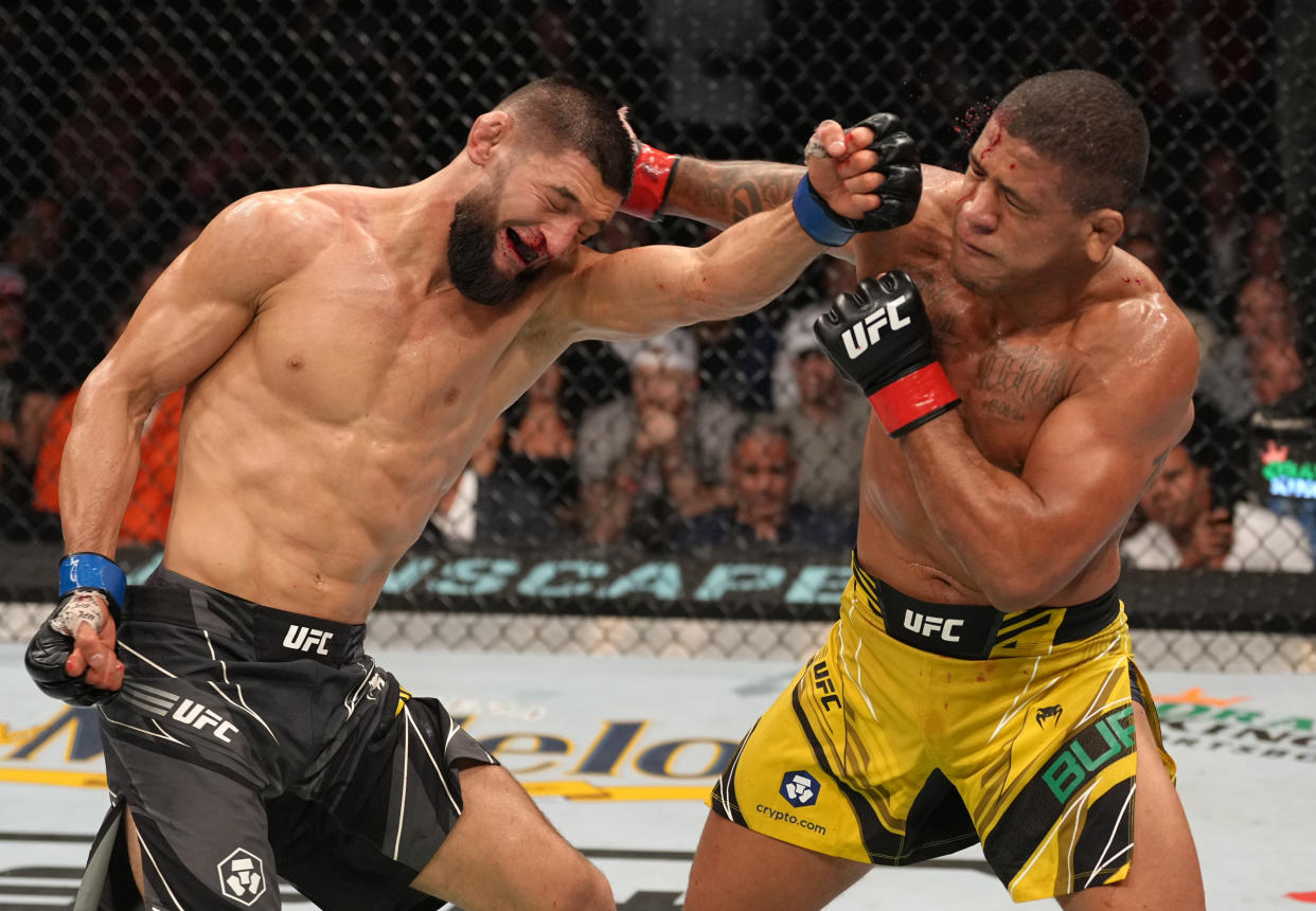 JACKSONVILLE, FLORIDA - APRIL 09: (R-L) Gilbert Burns of Brazil and Khamzat Chimaev of Russia trade punches in their welterweight fight during the UFC 273 event at VyStar Veterans Memorial Arena on April 09, 2022 in Jacksonville, Florida. (Photo by Jeff Bottari/Zuffa LLC)
