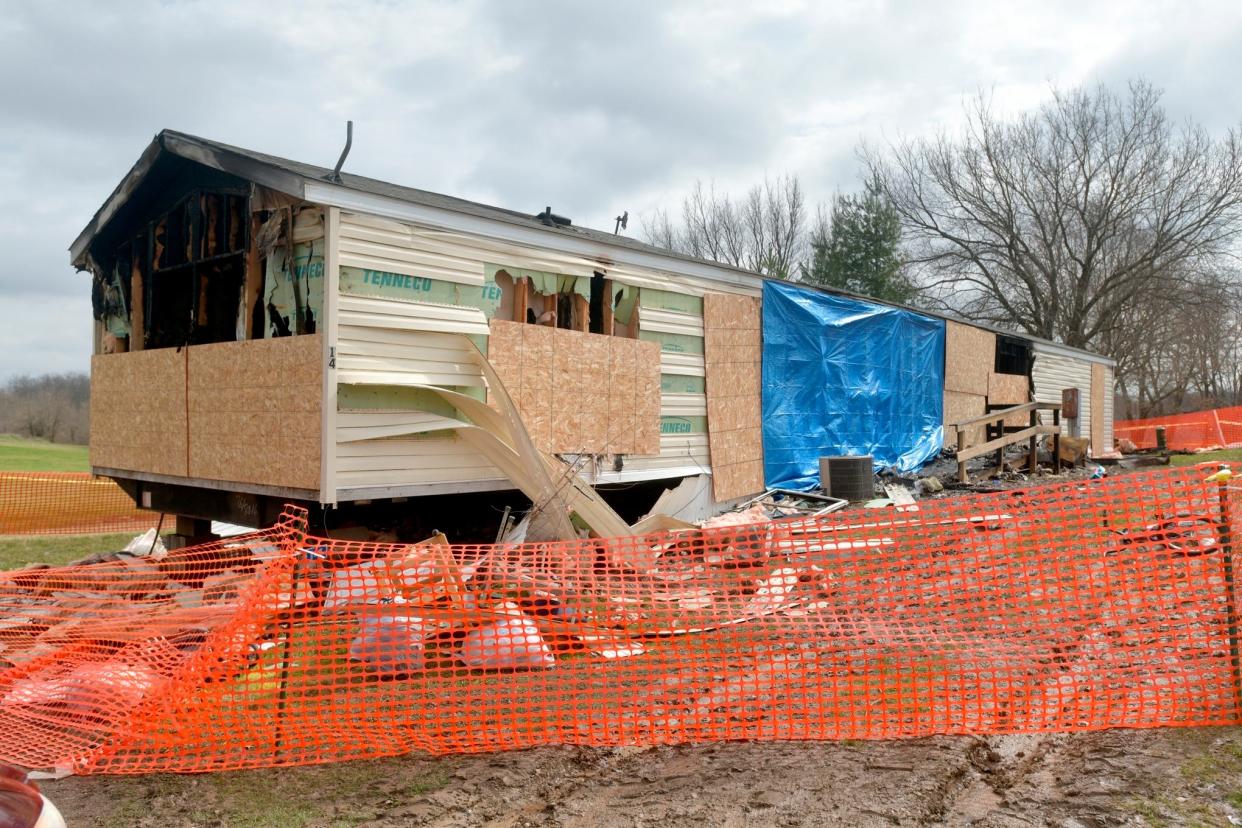 This photo taken April 7, 2019, shows a fence and caution tape surrounding a trailer home that was destroyed by fire in the Timberline Mobile Home Park northeast of Goodfield.