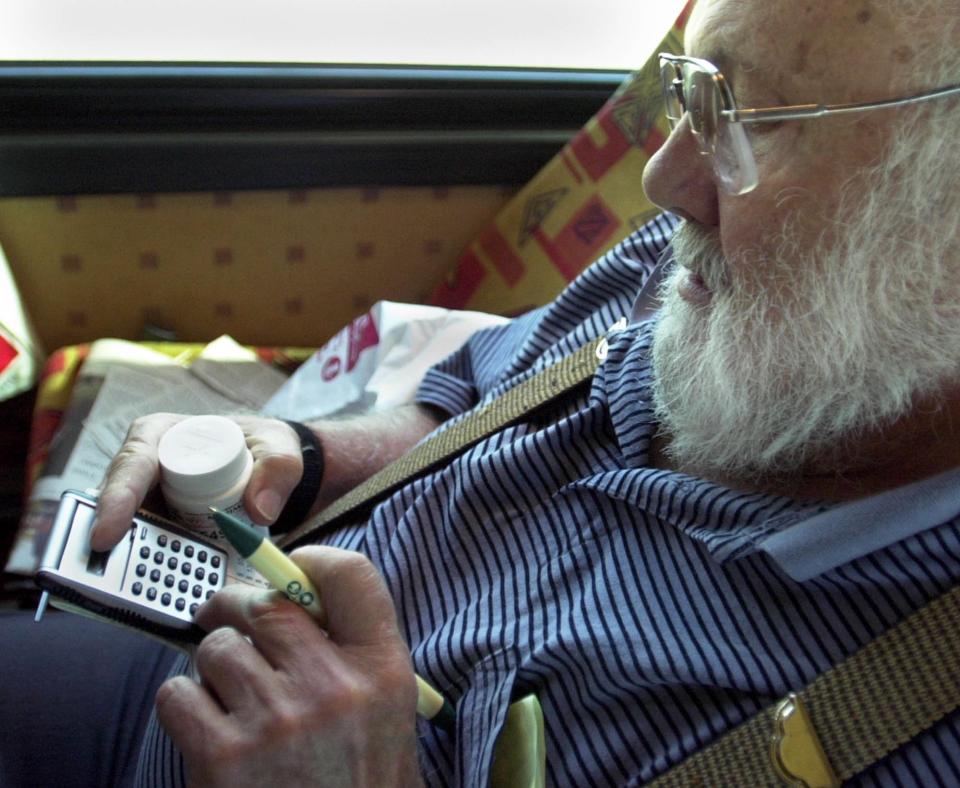 Winnipeg,Manitoba,Weds., July 23, 2003--Hugh Kurtzman, 74 years old from Minnetonka, calculates his savings on the prescription drugs he bought in Canada at the Family HealthCare MediMart Pharmacy & Home Care Supplies in Winnipeg.  Kurtzman went back to the bus to make his calculations as others in the group who rode the Minnesota Senior Federation Rx Express from Anoka to Canada bought their drugs.  Kurtzman said he realized the greatest savings on Metformin, a drug he takes for diabetes.  He will save $200 a year on that alone.(Photo By JOEY MCLEISTER/Star Tribune via Getty Images)