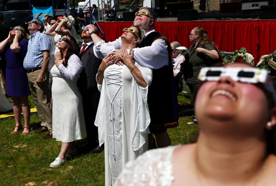  Couples look at the eclipse during a mass wedding ceremony in Russellville, Ark. (Mario Tama / Getty Images)