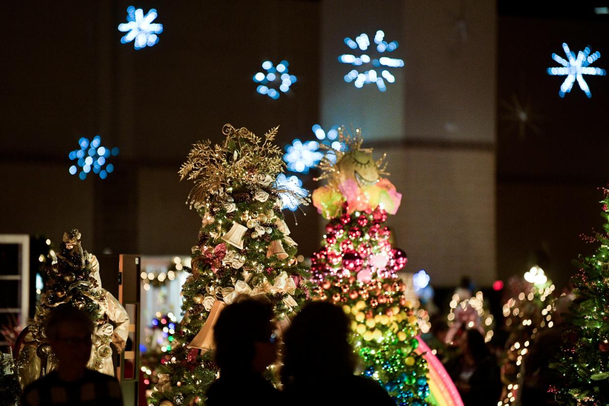 Visitors browse displays as snowflake lights twinkle above at East Tennessee Children's Hospital's Fantasy of Trees annual fundraising event at the Knoxville Convention Center in downtown Knoxville, Tenn., on Tuesday, Nov. 22, 2022.