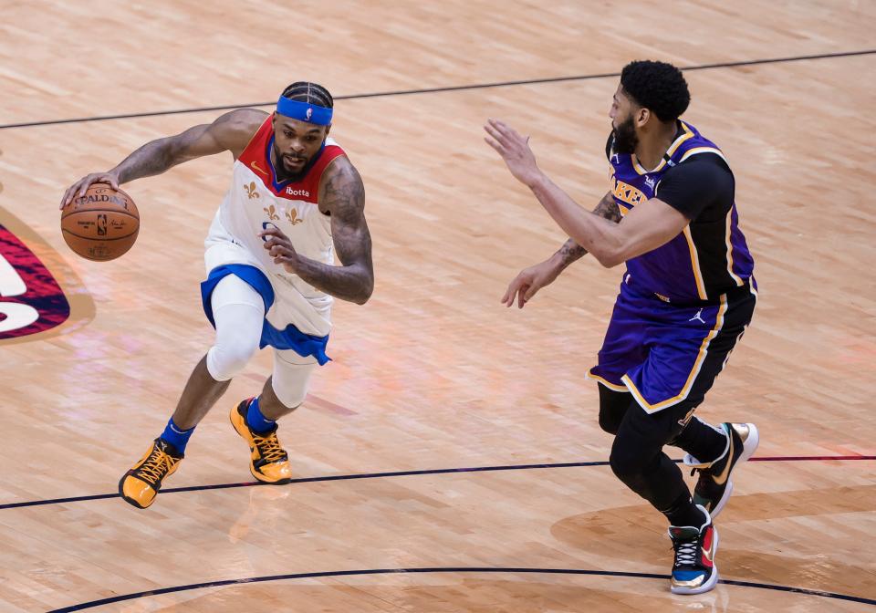 New Orleans Pelicans forward Naji Marshall (8) drives on Los Angeles Lakers forward Anthony Davis (3) in the third quarter of an NBA basketball game in New Orleans, Sunday, May 16, 2021. (AP Photo/Derick Hingle)